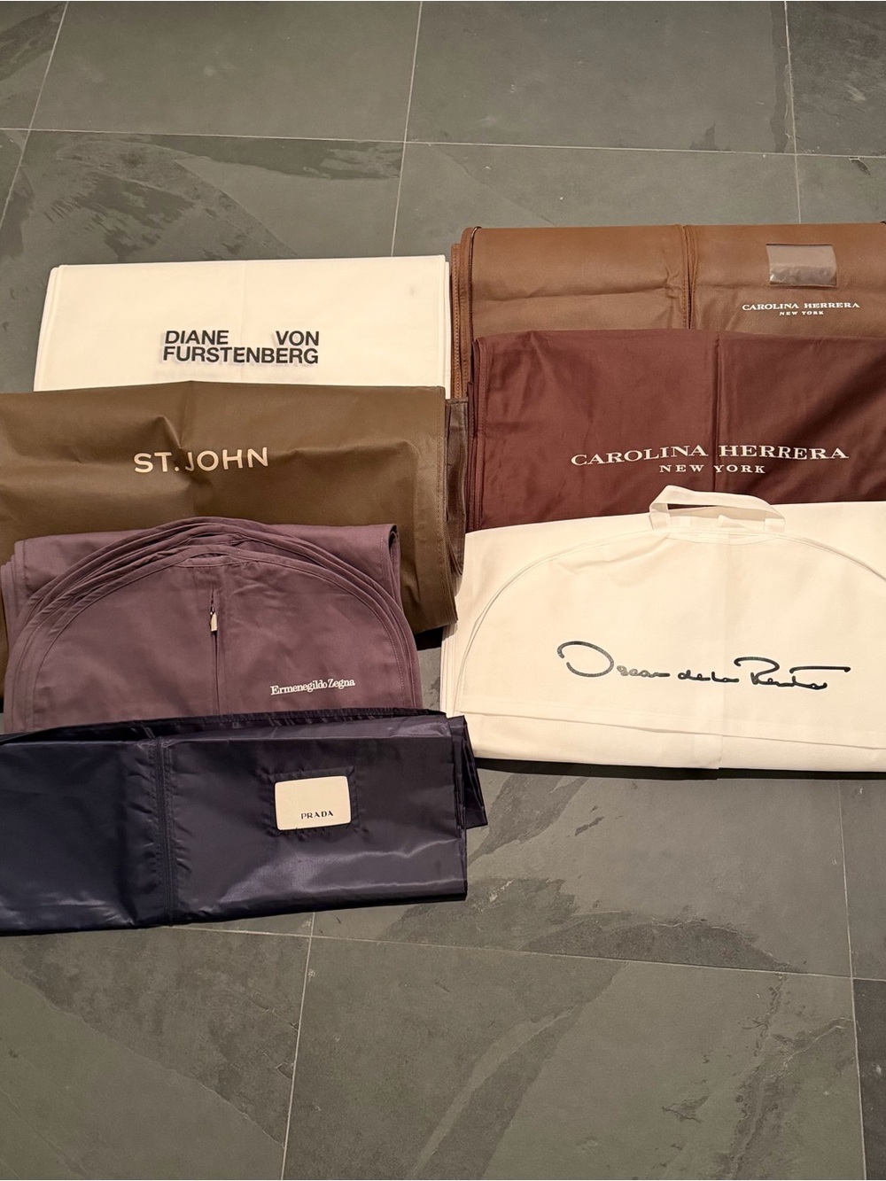 Bundle of 26 designer garment bags.